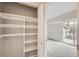 Walk in closet with built in shelving. View into the main room with balcony access at 4899 S Dudley St # 17G, Littleton, CO 80123