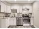 Bright kitchen with white cabinetry, stainless steel appliances and granite countertops at 4899 S Dudley St # 17G, Littleton, CO 80123