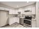 Modern kitchen with white cabinets, subway tile backsplash, and stainless steel appliances at 4899 S Dudley St # 17G, Littleton, CO 80123