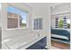 A luxurious bathtub is set against a window with a view, adjacent to a bedroom for convenience at 20529 E Brunswick Pl, Aurora, CO 80013