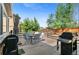 A wooden deck features a dining table set, grill, and shaded area perfect for outdoor relaxation and entertainment at 20529 E Brunswick Pl, Aurora, CO 80013