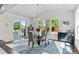 Modern dining area with large windows and sliding door to outdoor deck at 20529 E Brunswick Pl, Aurora, CO 80013