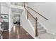 Bright foyer featuring hardwood floors, a staircase with white railing, and views into the living area at 20529 E Brunswick Pl, Aurora, CO 80013