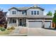 Charming two-story home with a well-manicured lawn, stone accents, and a three-car garage at 20529 E Brunswick Pl, Aurora, CO 80013