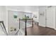 Light-filled foyer with dark floors and white banister, offers a welcoming view of the home's interior at 20529 E Brunswick Pl, Aurora, CO 80013