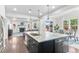 Bright, open kitchen with island, pendant lighting, and view into the living room at 20529 E Brunswick Pl, Aurora, CO 80013