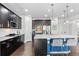 Modern kitchen with dark wood cabinets, stainless steel appliances, and large island with barstool seating at 20529 E Brunswick Pl, Aurora, CO 80013