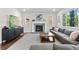 Inviting living room featuring a stone fireplace, a large TV, and a comfortable sectional sofa at 20529 E Brunswick Pl, Aurora, CO 80013
