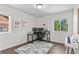 Bright home office with large windows, ample desk space, and a piano, perfect for working and creating at 20529 E Brunswick Pl, Aurora, CO 80013