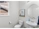 Comfortable powder room with an updated vanity, toilet, and decor, offering convenience for guests at 20529 E Brunswick Pl, Aurora, CO 80013