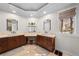 Spacious bathroom with dual vanities, a makeup area, travertine flooring, and ample lighting at 2230 E Grand Ave, Cherry Hills Village, CO 80113