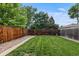 Fenced backyard features a lawn and garden at 2640 S Marion St # 2646, Denver, CO 80210