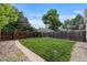 Backyard boasts green grass and a wooden fence at 2640 S Marion St # 2646, Denver, CO 80210