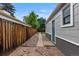 Side yard features stone walkway and gated access at 2640 S Marion St # 2646, Denver, CO 80210