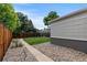 A backyard space with a wooden fence and a stone path and rock landscaping at 2640 S Marion St # 2646, Denver, CO 80210