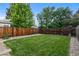 Backyard boasts green grass and a wooden fence at 2640 S Marion St # 2646, Denver, CO 80210