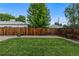 Backyard boasts green grass and a wooden fence at 2640 S Marion St # 2646, Denver, CO 80210