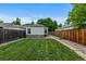 A well-maintained backyard features a green lawn and a wooden fence for privacy at 2640 S Marion St # 2646, Denver, CO 80210