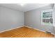 Bedroom with hardwood floors and a bright window with blinds at 2640 S Marion St # 2646, Denver, CO 80210