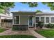 Charming home featuring a welcoming entrance with a teal front door and well-manicured landscaping at 2640 S Marion St # 2646, Denver, CO 80210