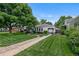 Charming home boasting lush lawn and stone walkway, set under a mature shade tree at 2640 S Marion St # 2646, Denver, CO 80210