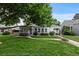 Charming home with a well-maintained front yard, mature tree, and inviting walkway at 2640 S Marion St # 2646, Denver, CO 80210