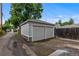 Two-car garage with neutral paint and alley access surrounded by mature trees at 2640 S Marion St # 2646, Denver, CO 80210