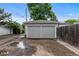 Two-car garage with neutral paint and alley access adjacent to wooden fence at 2640 S Marion St # 2646, Denver, CO 80210