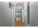 Hallway featuring hardwood floors and neutral paint leading to various rooms at 2640 S Marion St # 2646, Denver, CO 80210