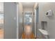 Hallway featuring hardwood floors and neutral paint leading to various rooms at 2640 S Marion St # 2646, Denver, CO 80210