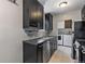 Modern kitchen featuring dark cabinetry, stainless steel appliances, and sleek countertops at 2640 S Marion St # 2646, Denver, CO 80210