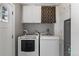Bright laundry room with washer, dryer, and white cabinets at 2640 S Marion St # 2646, Denver, CO 80210