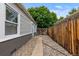 Side yard with narrow stone path, rock landscaping, and access gate to backyard at 2640 S Marion St # 2646, Denver, CO 80210