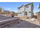 The backyard features a retaining wall, patio, and small grass area at 3266 Riverwood Way, Castle Rock, CO 80109