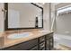 The bathroom includes a double sink vanity with a large mirror, and shower with gray tile and glass doors at 3266 Riverwood Way, Castle Rock, CO 80109