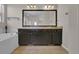 Bathroom boasts dual sinks, a vanity, a large mirror and a bathtub at 3266 Riverwood Way, Castle Rock, CO 80109