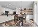 Charming dining area with hardwood floors, decorative shelves, and seamless access to an open-concept kitchen at 3266 Riverwood Way, Castle Rock, CO 80109