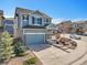 Beautiful blue two-story home with a two-car garage, complemented by a neatly landscaped front yard and driveway at 3266 Riverwood Way, Castle Rock, CO 80109