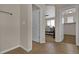Hallway with beige walls and brown tile flooring that leads to a bedroom and a walk-in closet at 3266 Riverwood Way, Castle Rock, CO 80109