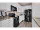 Modern kitchen features stainless steel appliances, granite counters, and white cabinets at 3266 Riverwood Way, Castle Rock, CO 80109