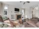 Comfortable living room showcasing a stone fireplace, large windows, and hardwood floors, perfect for relaxation at 3266 Riverwood Way, Castle Rock, CO 80109
