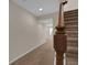 Carpeted stairs with wood railing and neutral-colored walls, leading to the basement at 3266 Riverwood Way, Castle Rock, CO 80109