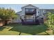 Backyard featuring a well-maintained lawn, two-story deck, and small shed at 9905 Aftonwood St, Highlands Ranch, CO 80126