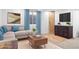Cozy basement living space with a modern sectional sofa and dark cabinet at 9905 Aftonwood St, Highlands Ranch, CO 80126