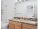 This is a bright bathroom featuring double sinks, granite countertops and a shower/tub combo at 9905 Aftonwood St, Highlands Ranch, CO 80126