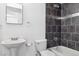 Modern bathroom with dark tile shower, vanity sink and toilet at 9905 Aftonwood St, Highlands Ranch, CO 80126