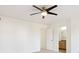 This is a bright bedroom with a modern ceiling fan and ensuite bathroom access at 9905 Aftonwood St, Highlands Ranch, CO 80126