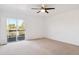 Empty bedroom with sliding glass doors leading to a private balcony at 9905 Aftonwood St, Highlands Ranch, CO 80126