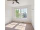 Bright bedroom featuring two sunny windows and neutral carpeting at 9905 Aftonwood St, Highlands Ranch, CO 80126