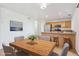 Dining area with wooden table, bar seating, and granite countertops at 9905 Aftonwood St, Highlands Ranch, CO 80126